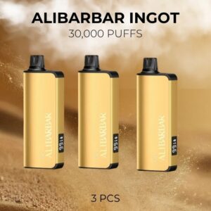 Three gold vape devices with black caps standing upright on a sandy background; text reads 'ALIBARBAR INGOT' and '30,000 PUFFS' (3 PCS).